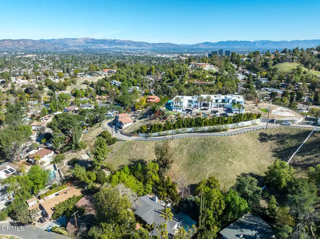 a view of a city with lush green forest
