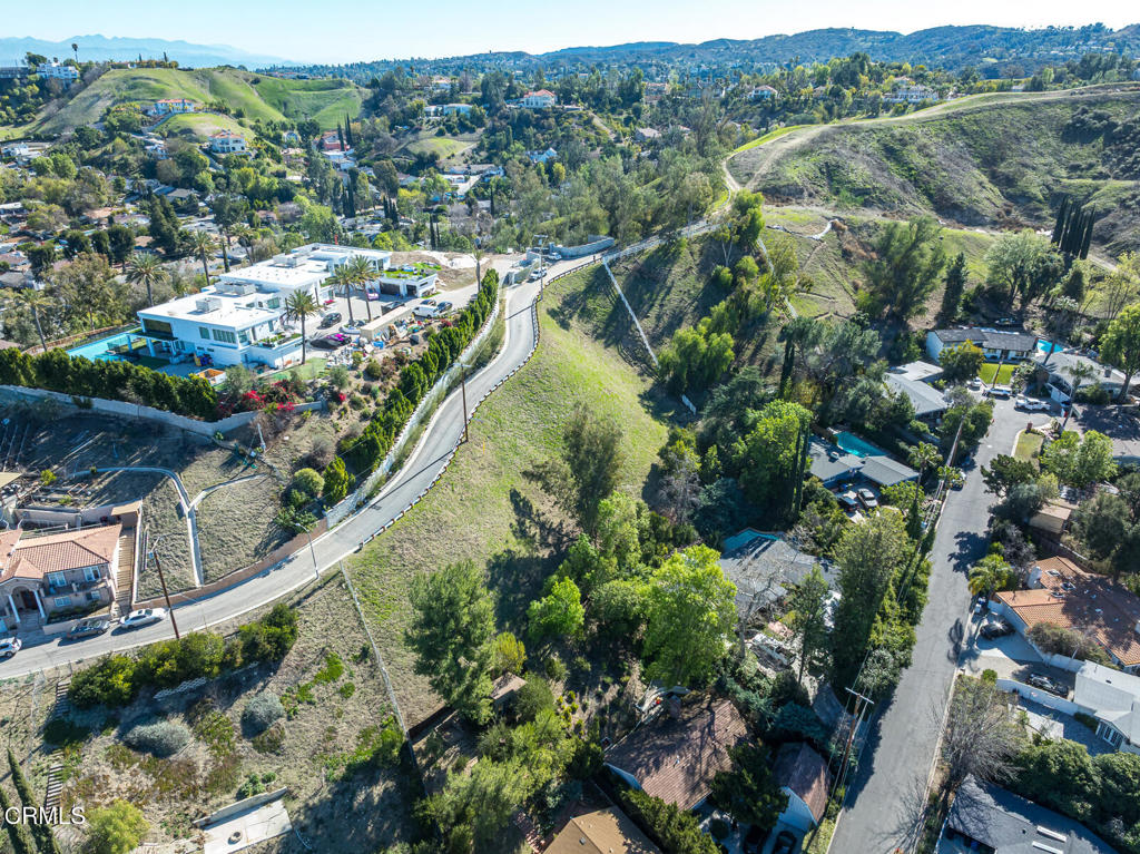 4845 Calderon Road Woodland Hills, CA 91364 - Photo 47 of 54 a view of a city with lush green forest
