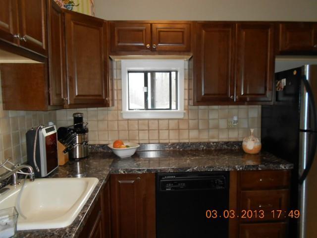 19 Keeler Close, Unit 19 Ridgefield, CT 06877 - Photo 1 of 1 a kitchen with granite countertop a sink stove and cabinets