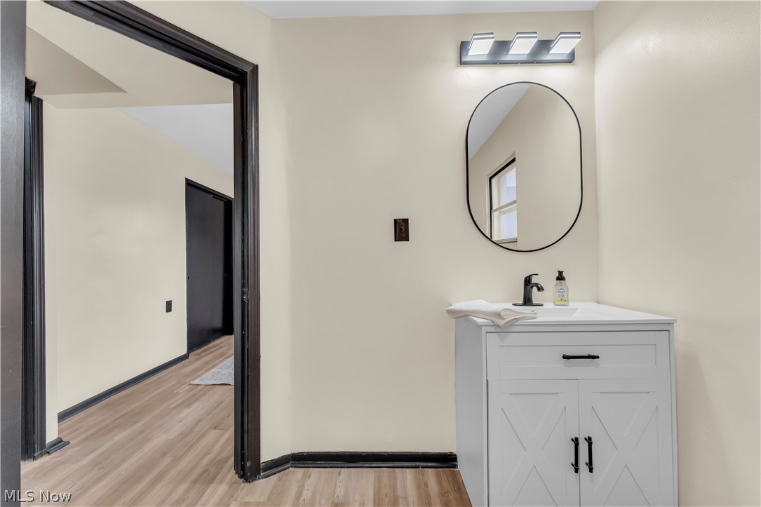 7320 Avon Belden Road North Ridgeville, OH 44039 - Photo 27 of 33 Half bath featuring vanity and light wood-type flooring