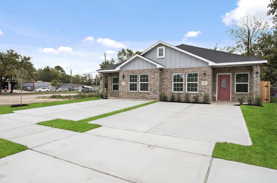 5222 Bataan Road Houston, TX 77033 - Photo 22 of 22 Elegant curb appeal with a spacious driveway, manicured lawn, and timeless brick exterior designed for modern luxury living.