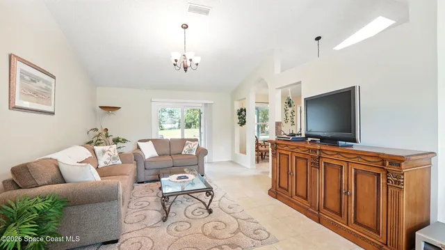a kitchen with granite countertop a sink a center island and stainless steel appliances