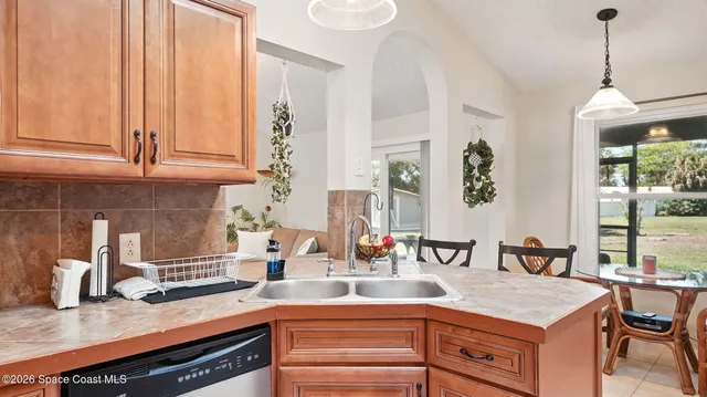 a view of a dining room with furniture large windows and wooden floor