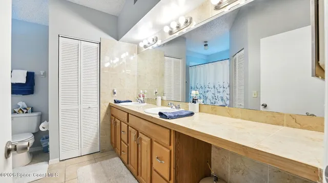 a view of walk in closet with clothes