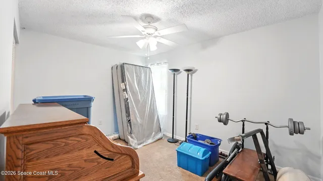 a dining room with furniture a floor to ceiling window and outside view