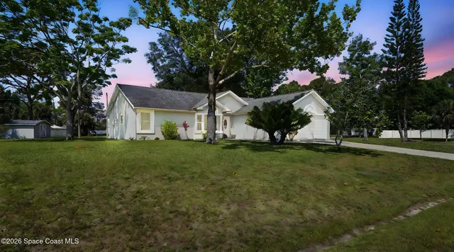 a living room with furniture a chandelier and a flat screen tv