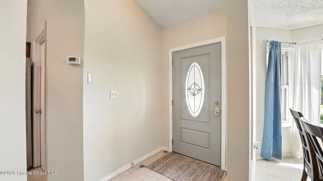 a living room with furniture a chandelier and a flat screen tv