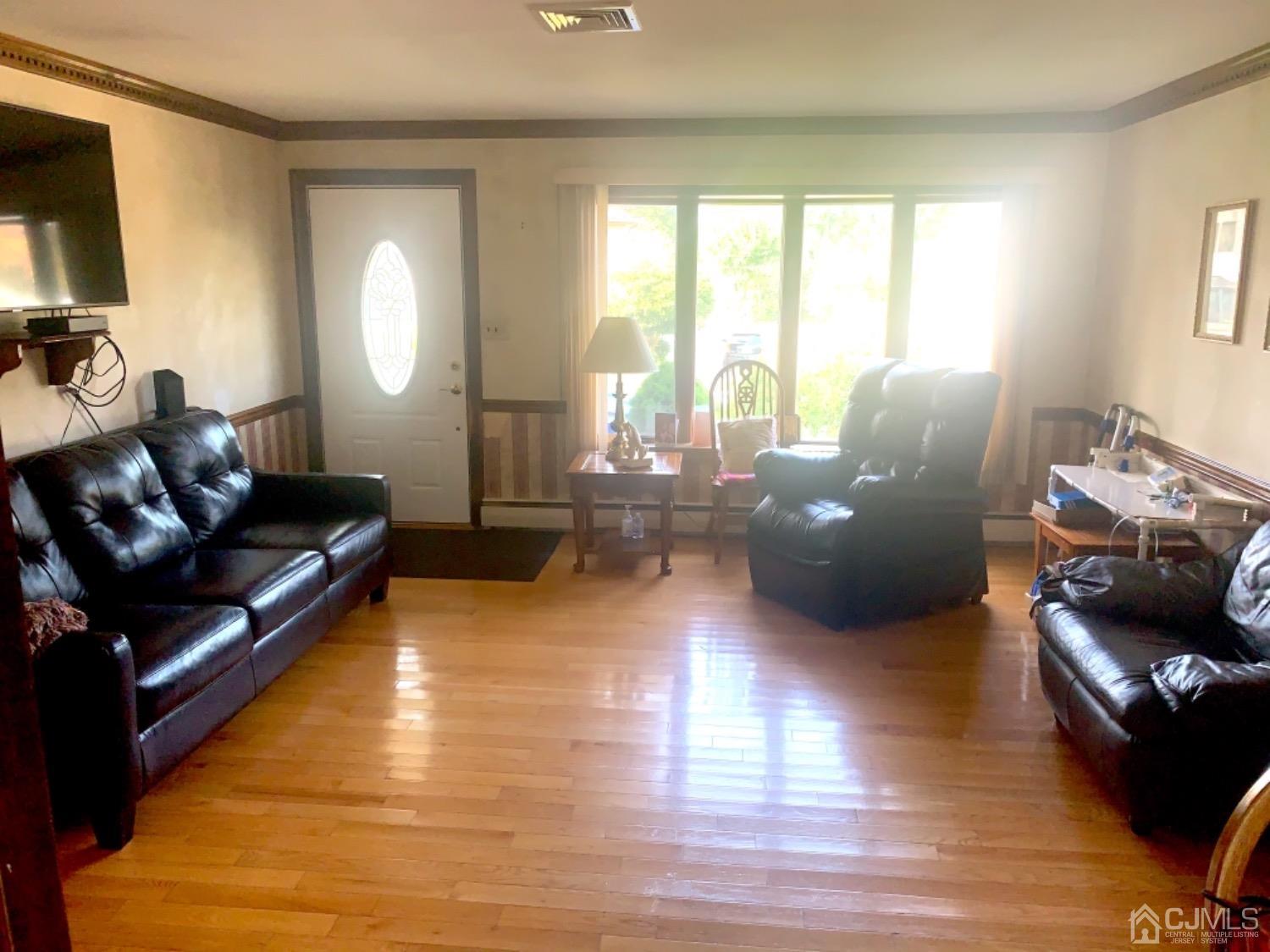 191 Oxford Road Colonia, NJ 07067 - Photo 17 of 23 a living room with furniture and a large window