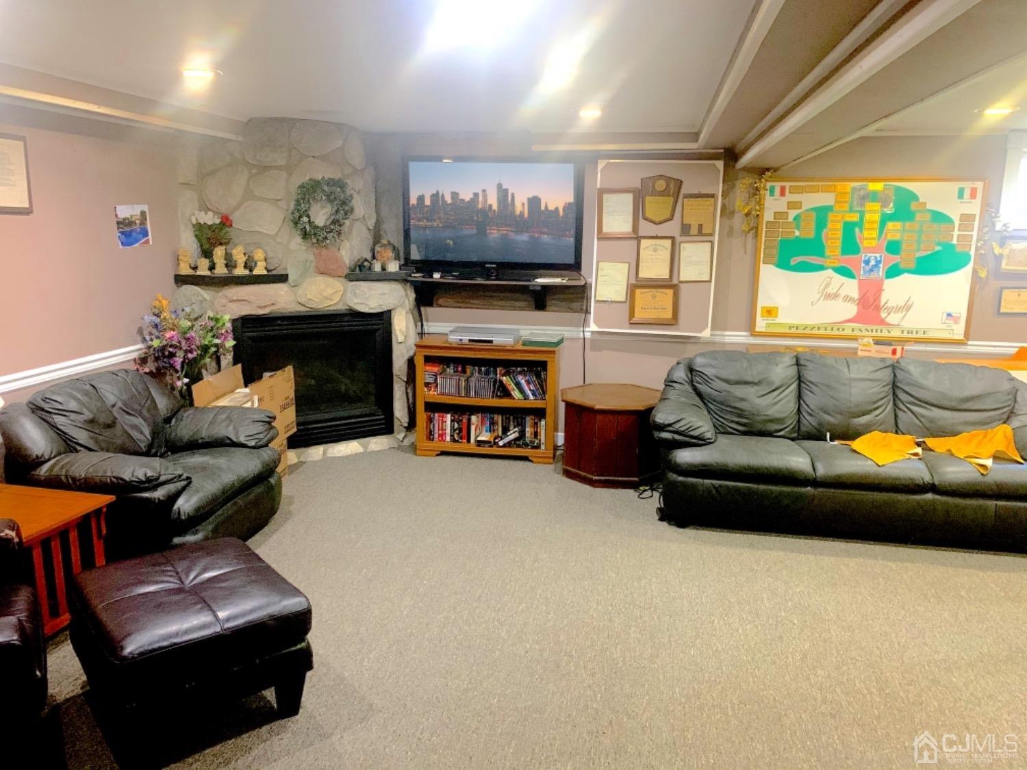 191 Oxford Road Colonia, NJ 07067 - Photo 23 of 23 a living room with furniture and a flat screen tv