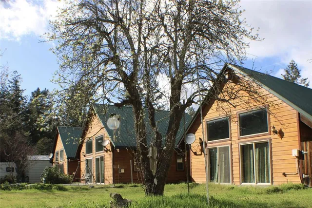 a view of white house with a yard