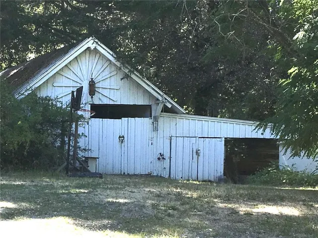 a view of a backyard with wooden fence and a yard
