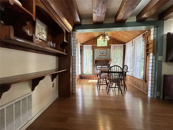 a dining room with furniture window fire place and wooden floor