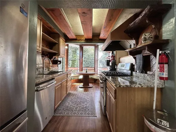 a kitchen with stainless steel appliances granite countertop lots of counter top space