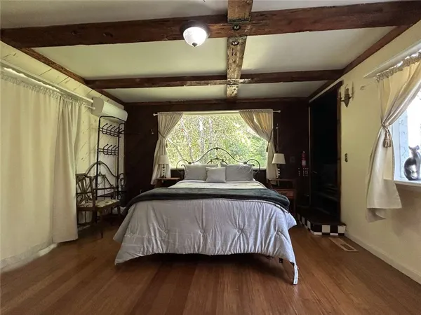 a bedroom with a bed and a large window