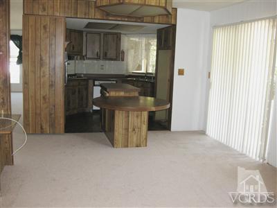 6480 Katherine Road, Unit 61 Simi Valley, CA 93063 - Photo 3 of 7 a view of an empty room with a fireplace and a window
