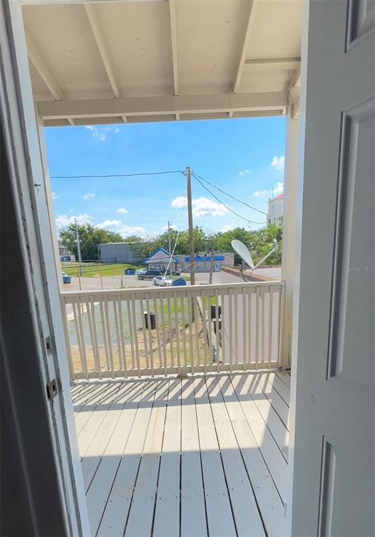 35 North 6th Street, Unit 8 Haines City, FL 33844 - Photo 13 of 17 a view of a balcony with a floor to ceiling window with wooden floor