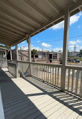 a view of balcony with wooden floor