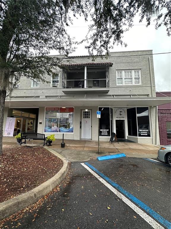35 North 6th Street, Unit 8 Haines City, FL 33844 - Photo 16 of 17 a front view of a building with lots of trees and empty space