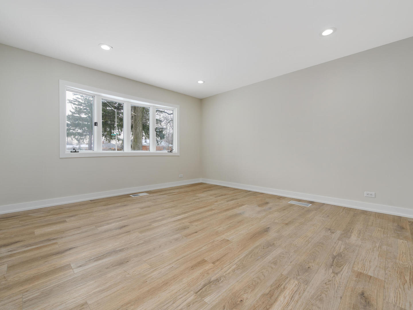 173 East Dennis Road Wheeling, IL 60090 - Photo 2 of 15 an empty room with wooden floor and windows