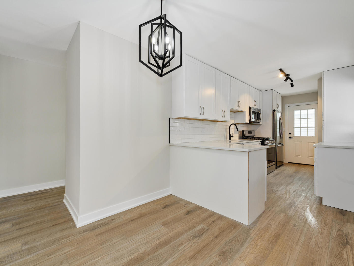 173 East Dennis Road Wheeling, IL 60090 - Photo 5 of 15 a view of a kitchen with wooden floor and a window