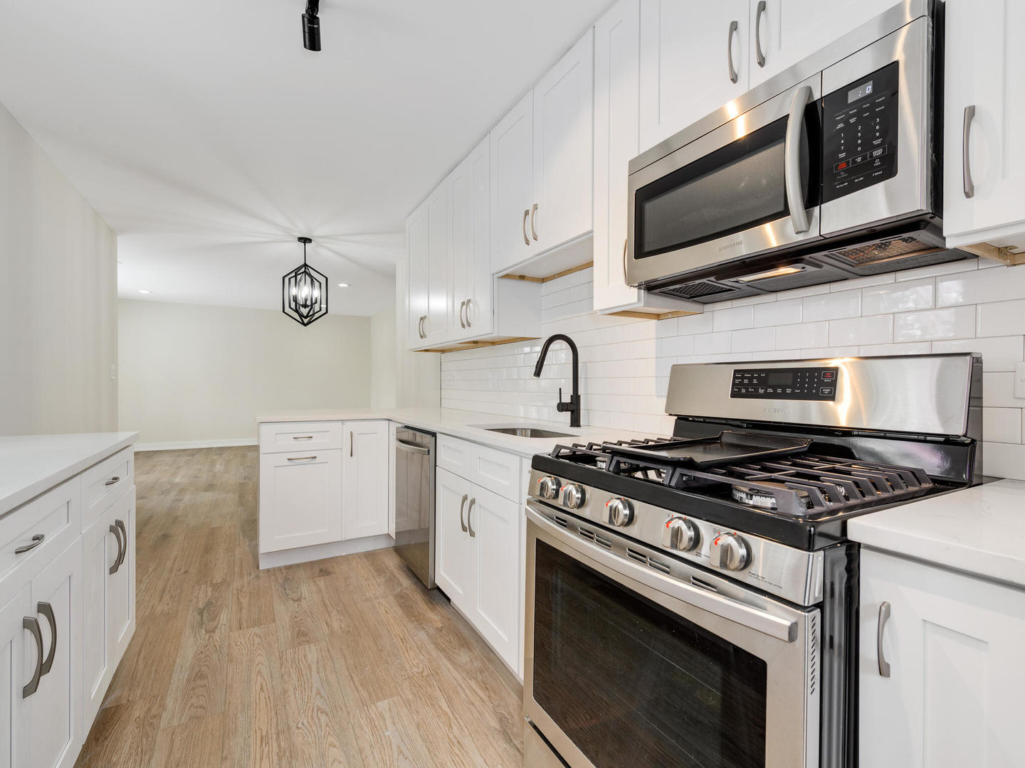 173 East Dennis Road Wheeling, IL 60090 - Photo 7 of 15 a kitchen with stainless steel appliances a stove a microwave and cabinets
