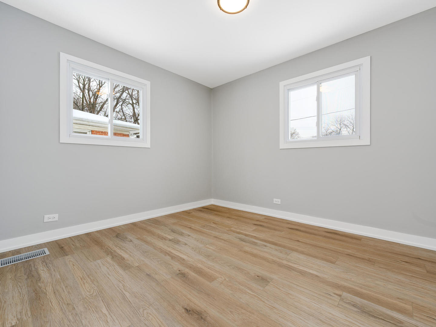 173 East Dennis Road Wheeling, IL 60090 - Photo 10 of 15 a view of an empty room with wooden floor and a window