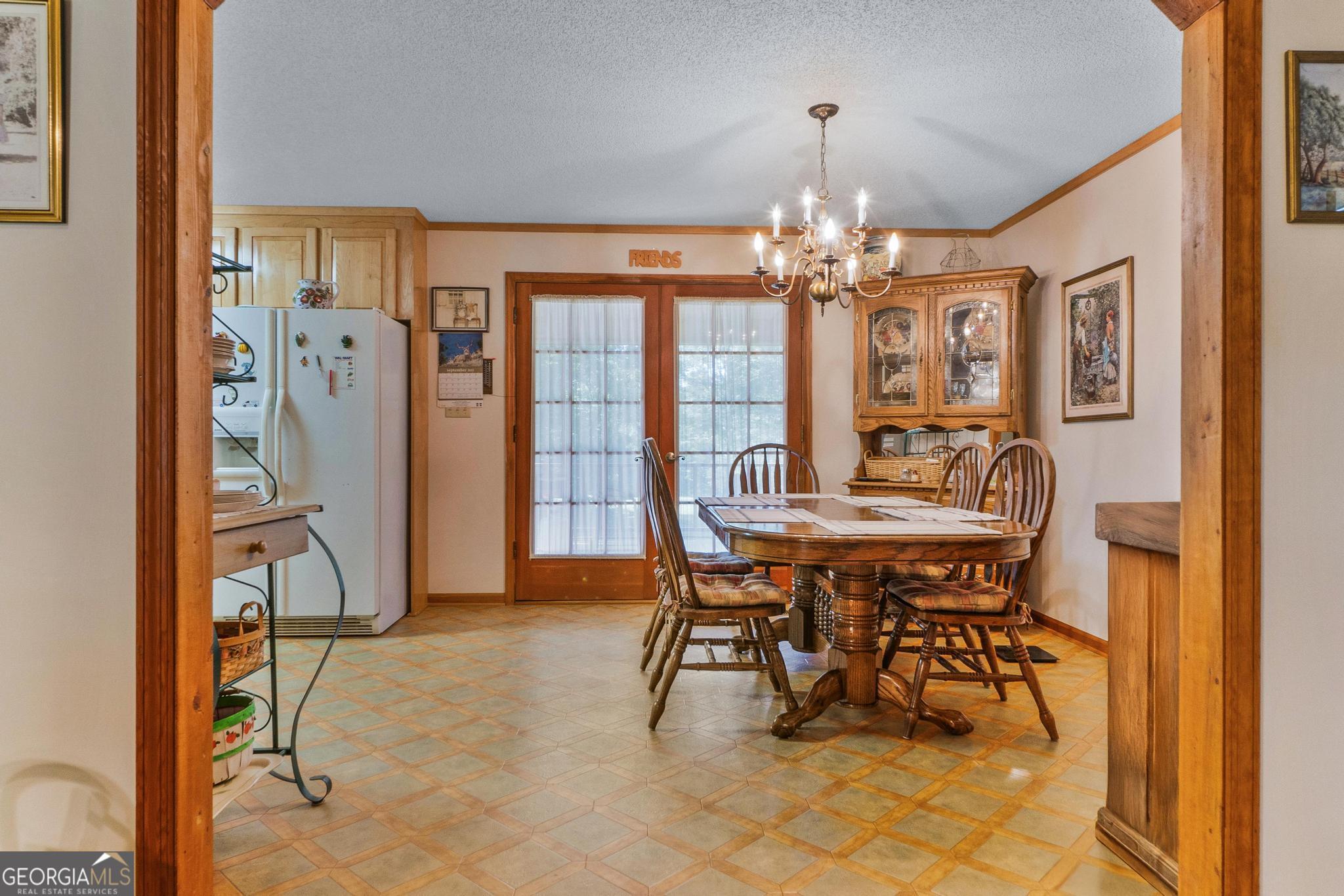 369 Abares Road Forsyth, GA 31029 - Photo 13 of 60 a view of a dining room with furniture and a chandelier