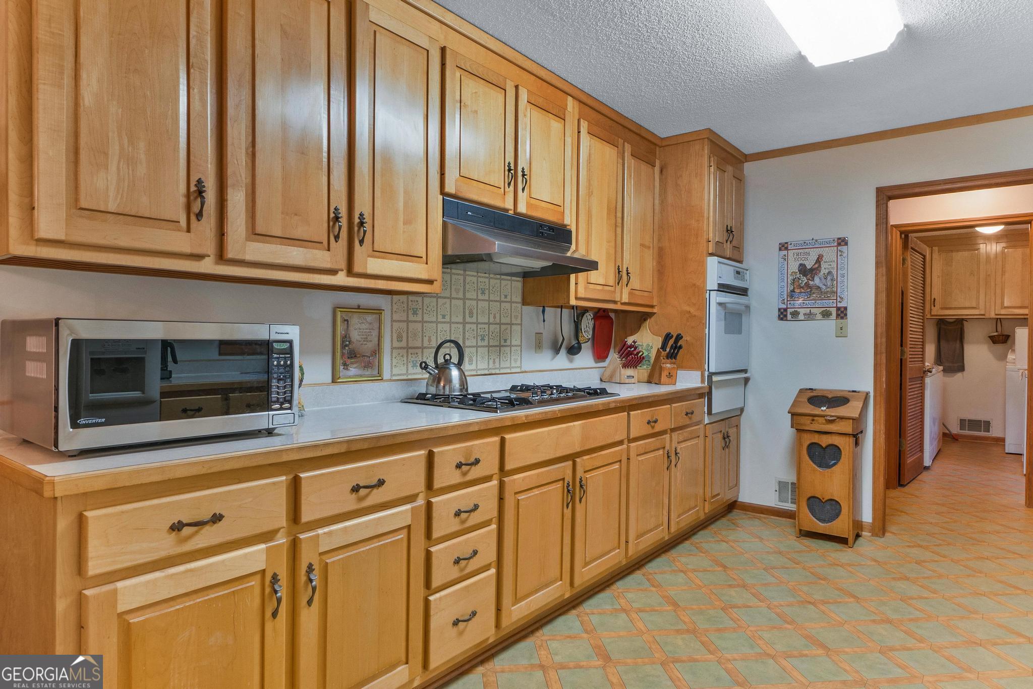 369 Abares Road Forsyth, GA 31029 - Photo 14 of 60 a kitchen with stainless steel appliances granite countertop a sink and a granite counter tops