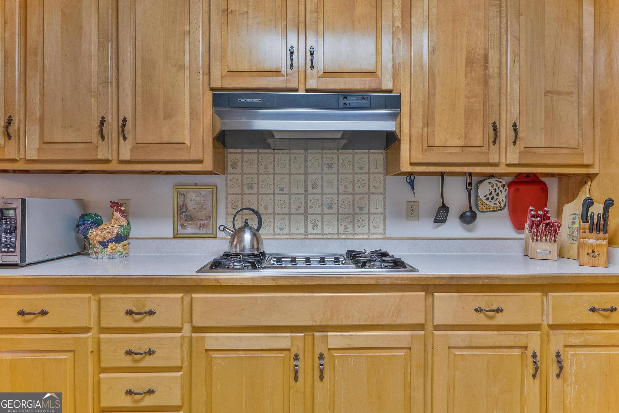 369 Abares Road Forsyth, GA 31029 - Photo 15 of 60 a kitchen with stainless steel appliances granite countertop a sink and cabinets