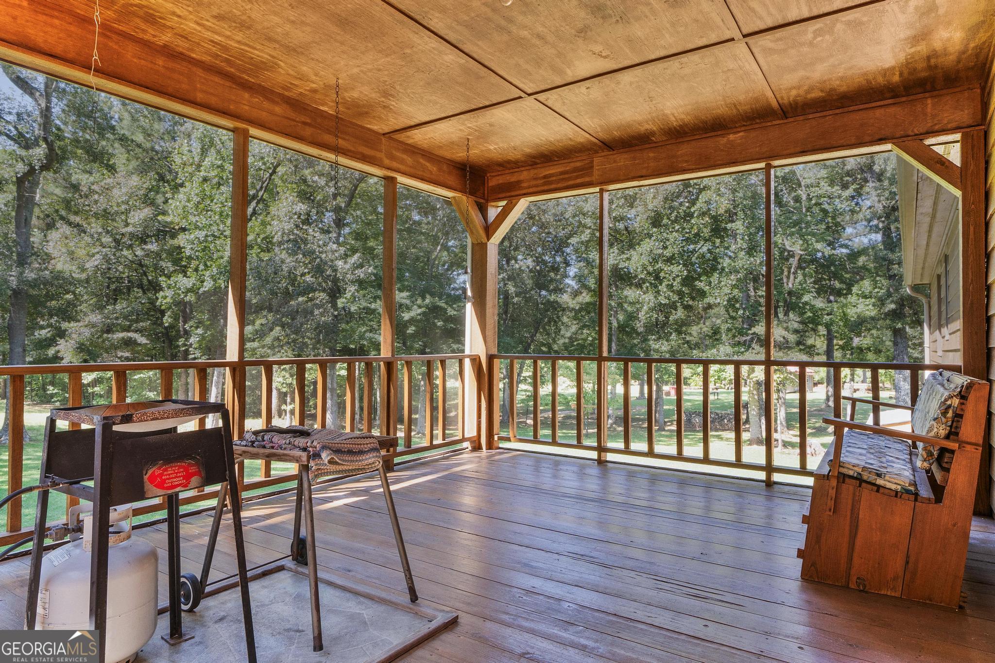 369 Abares Road Forsyth, GA 31029 - Photo 18 of 60 a view of a porch with furniture and wooden floor