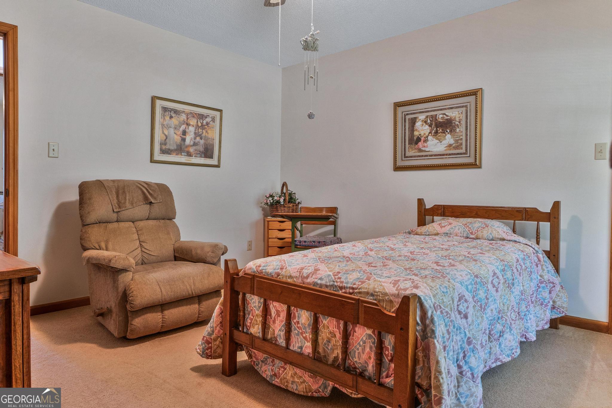 369 Abares Road Forsyth, GA 31029 - Photo 26 of 60 a bedroom with a bed and a couch