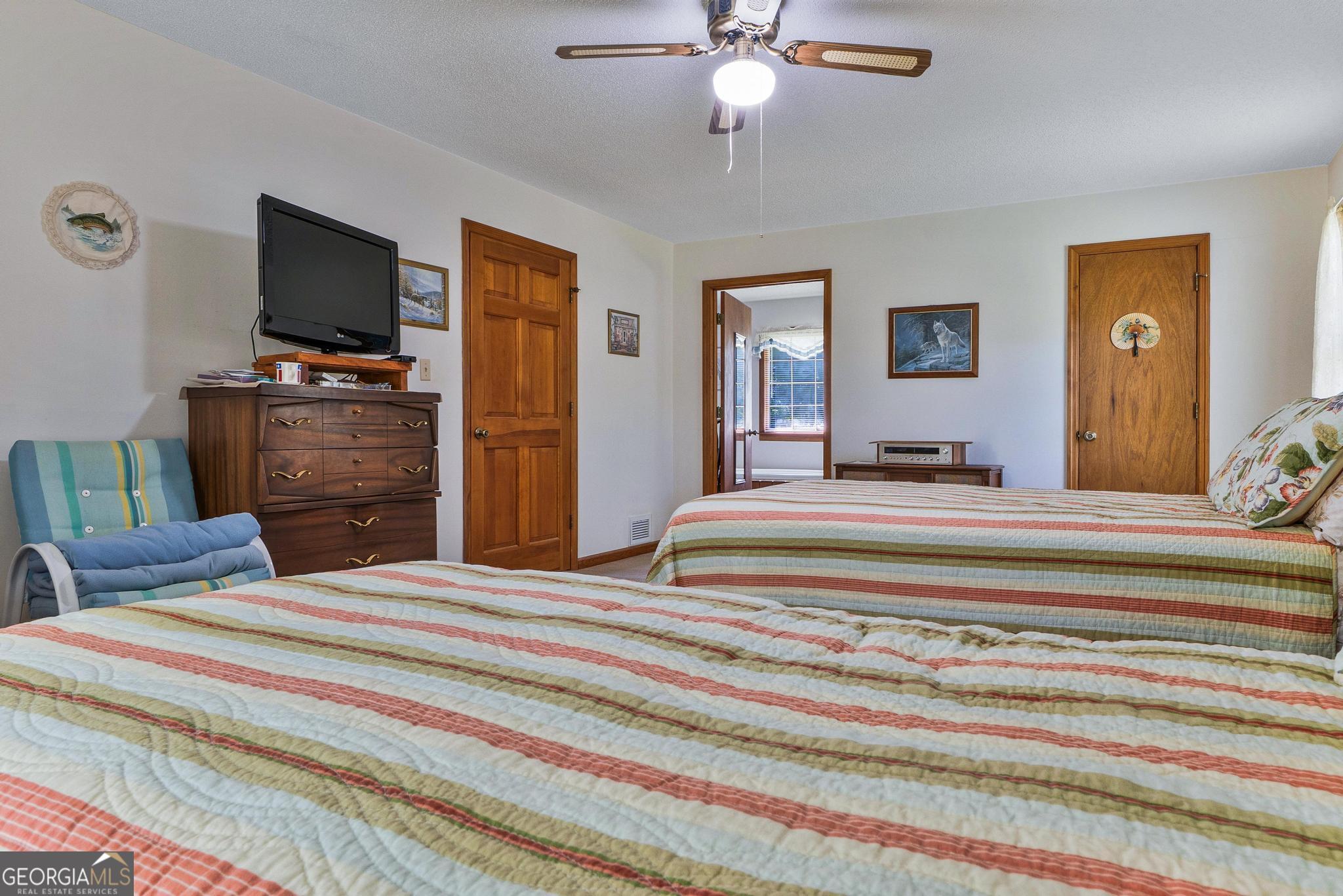 369 Abares Road Forsyth, GA 31029 - Photo 28 of 60 a bedroom with a bed and a flat screen tv