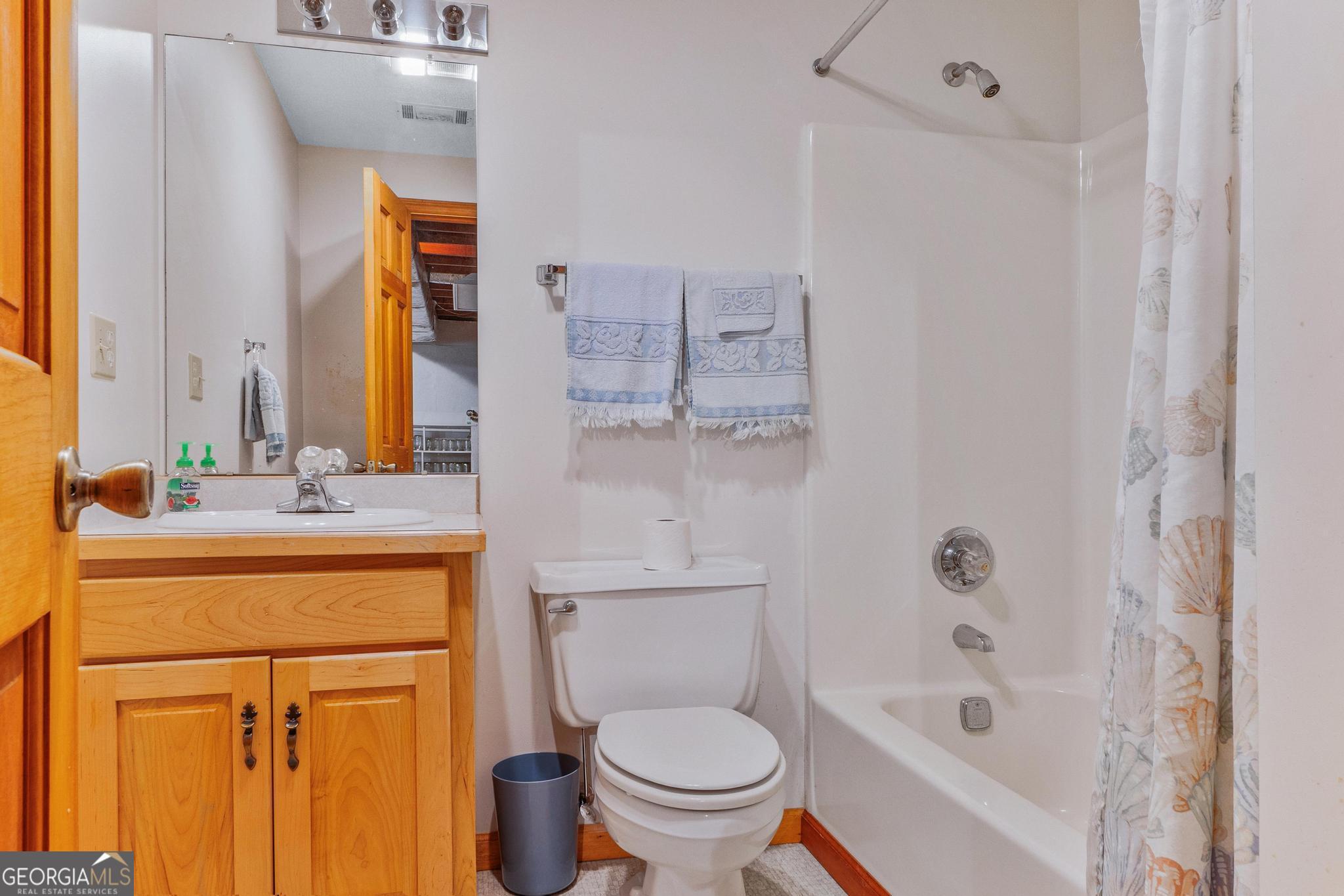 369 Abares Road Forsyth, GA 31029 - Photo 40 of 60 a bathroom with a granite countertop sink toilet and shower