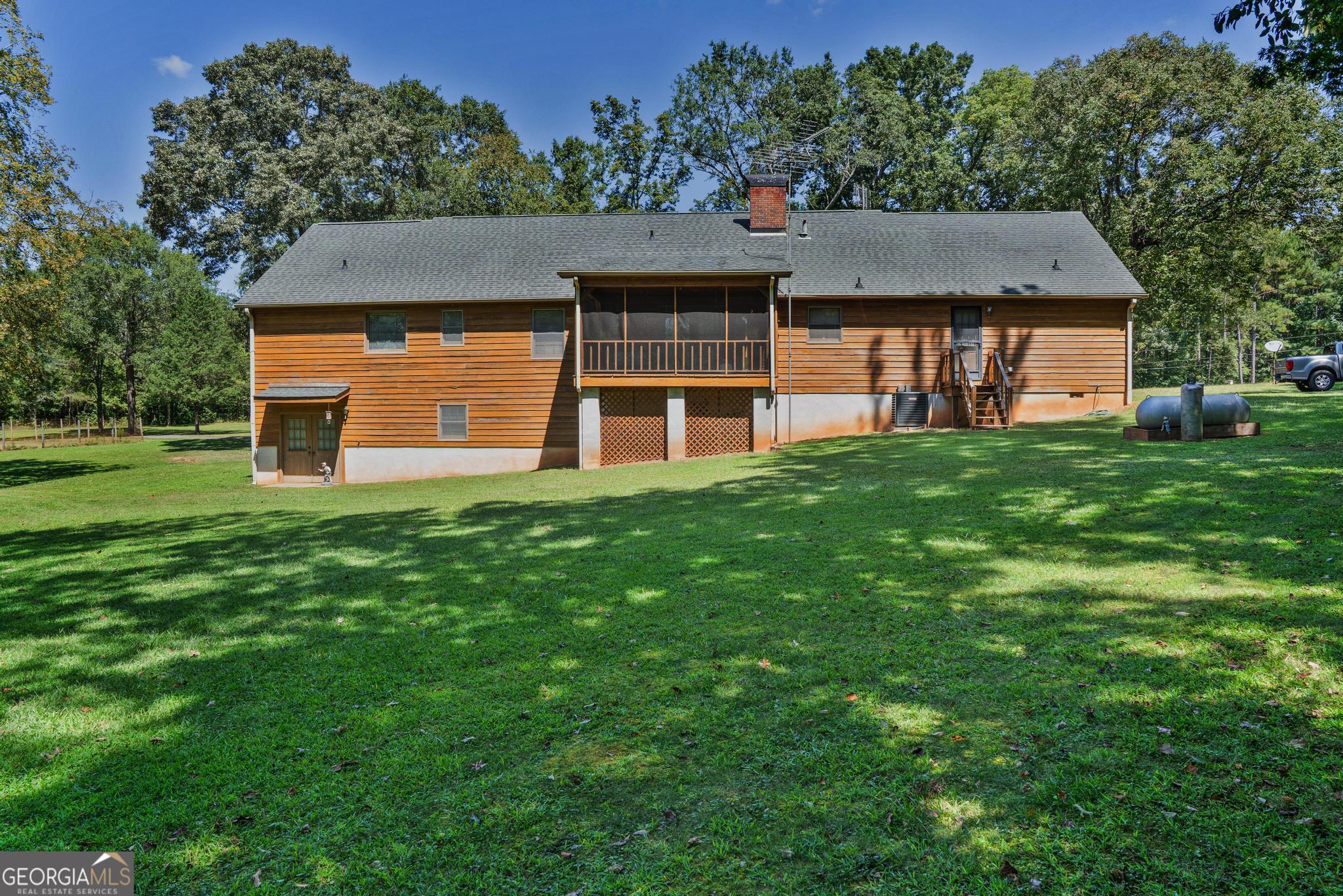 369 Abares Road Forsyth, GA 31029 - Photo 44 of 60 a front view of a house with a yard and garage
