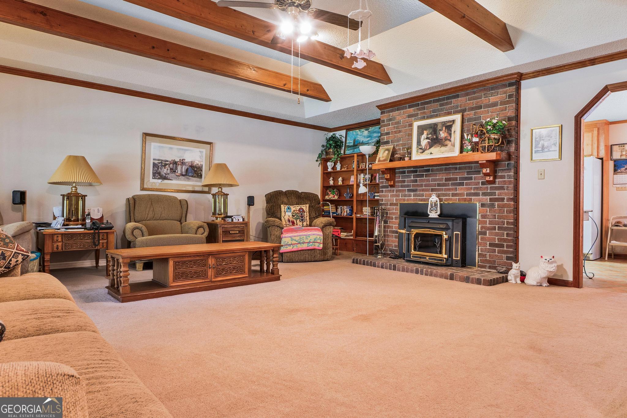 369 Abares Road Forsyth, GA 31029 - Photo 8 of 60 a living room with furniture and a fireplace