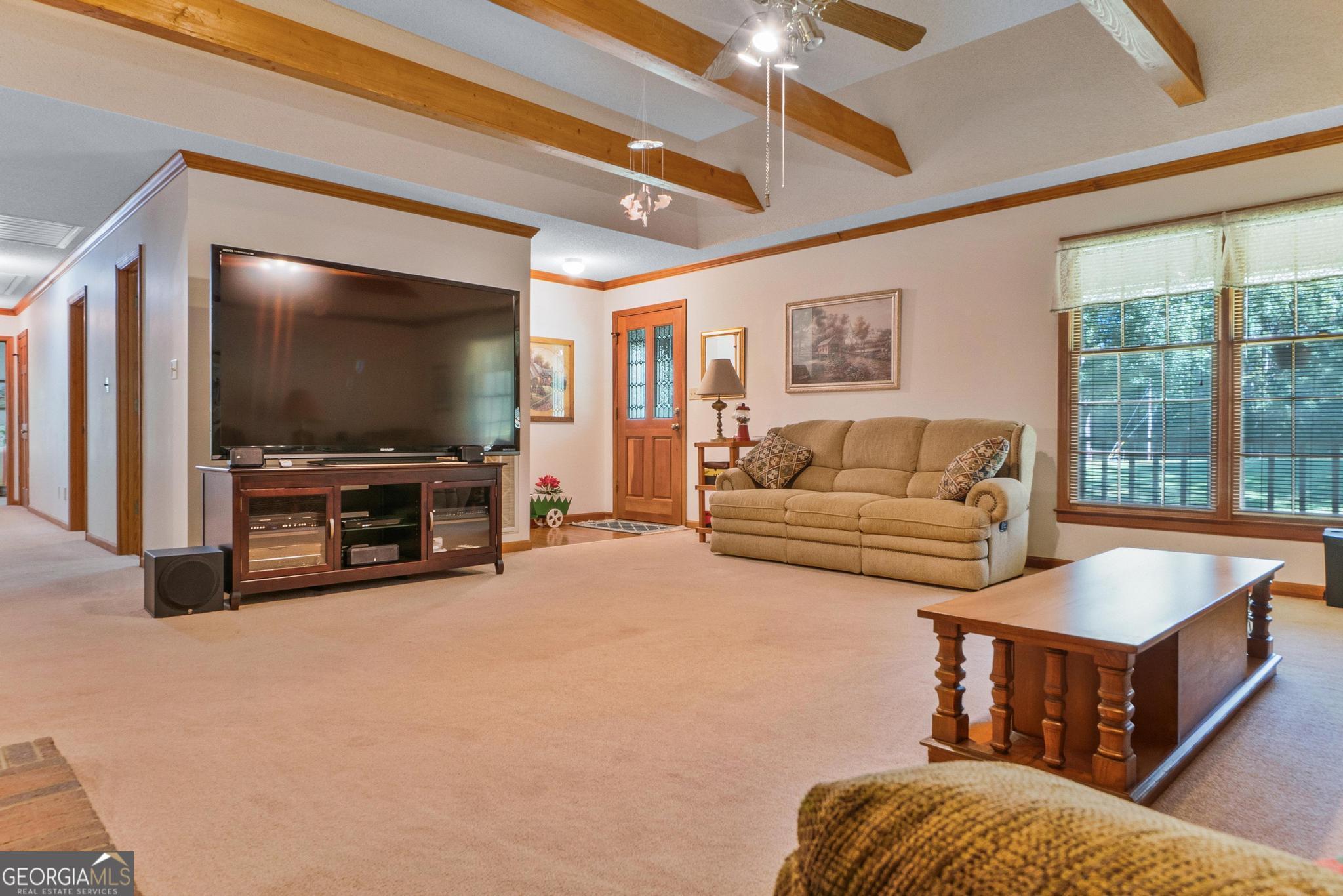 369 Abares Road Forsyth, GA 31029 - Photo 10 of 60 a living room with furniture and a flat screen tv