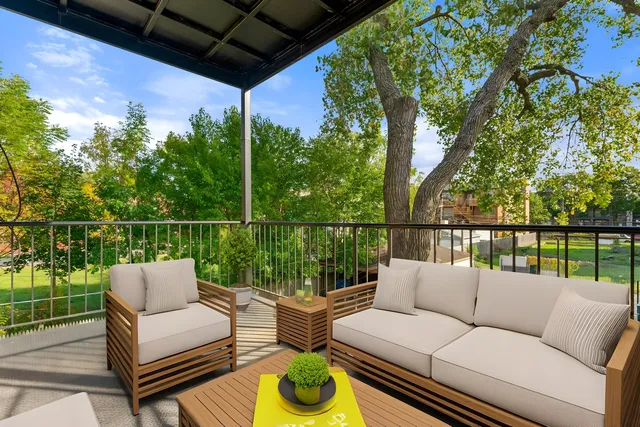 a balcony with furniture and a potted plant