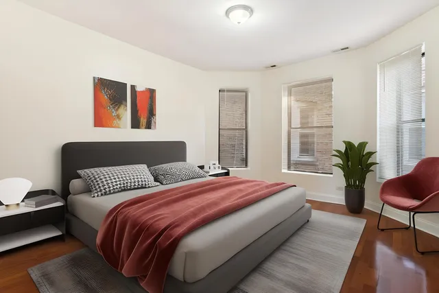 a bedroom with bed and a potted plant