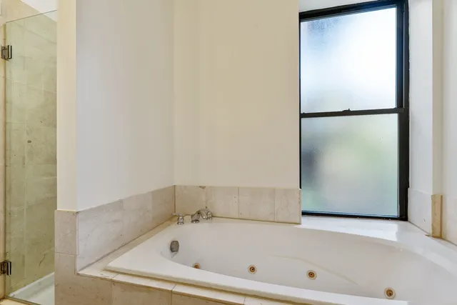 a bathroom with a bathtub and a shower