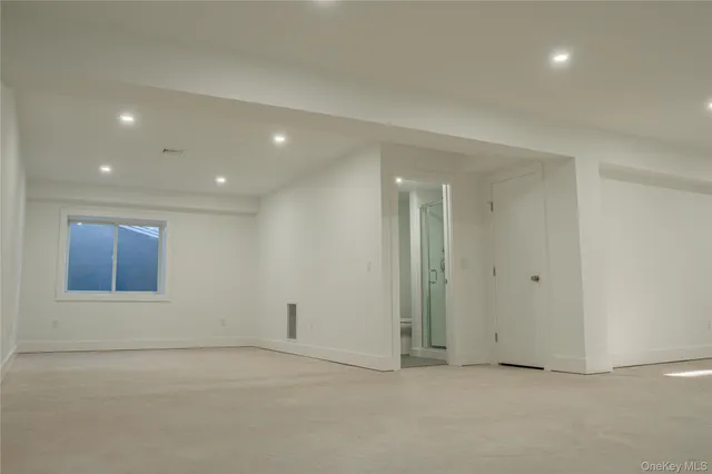 an empty room with a empty space and windows
