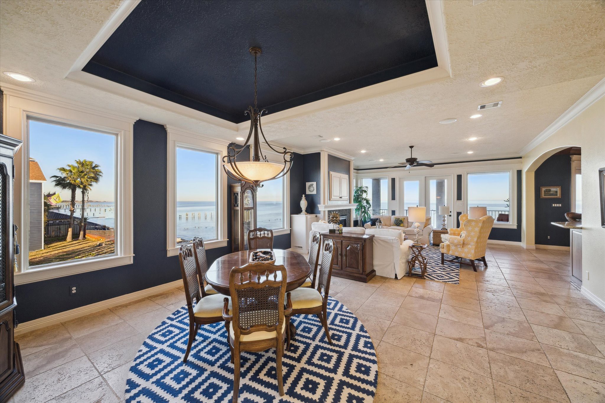 1406 Todville Road Seabrook, TX 77586 - Photo 12 of 50 OPEN DESIGN WITH WRAPAROUND WINDOWS EXTENDING FROM THE DINING ROOM TO THE DEN AND KITCHEN WHILE THE COFFERED CEILING WITH COVE MOLDING ADDS A TOUCH OF ELEGANCE.