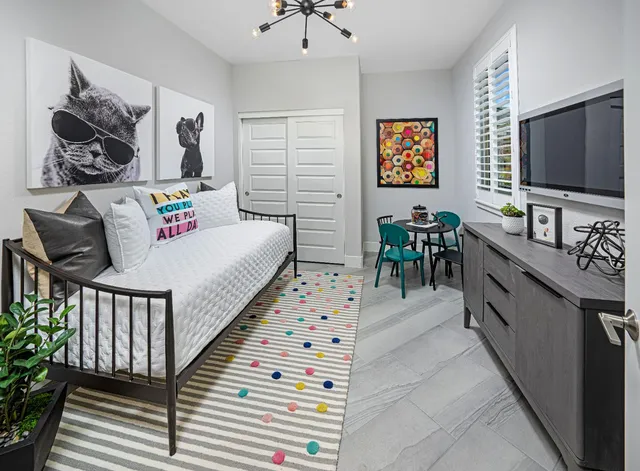 a bedroom with furniture and a flat screen tv