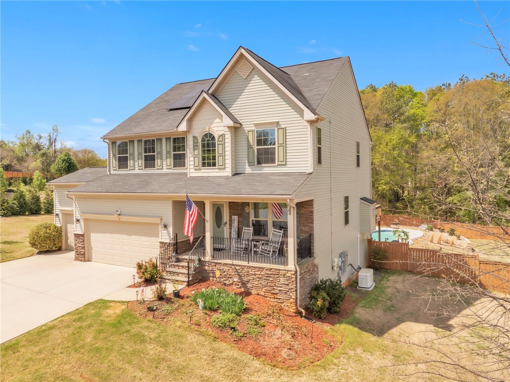 This charming residence features a well-maintained exterior and inviting front porch, perfect for enjoying outdoor living.