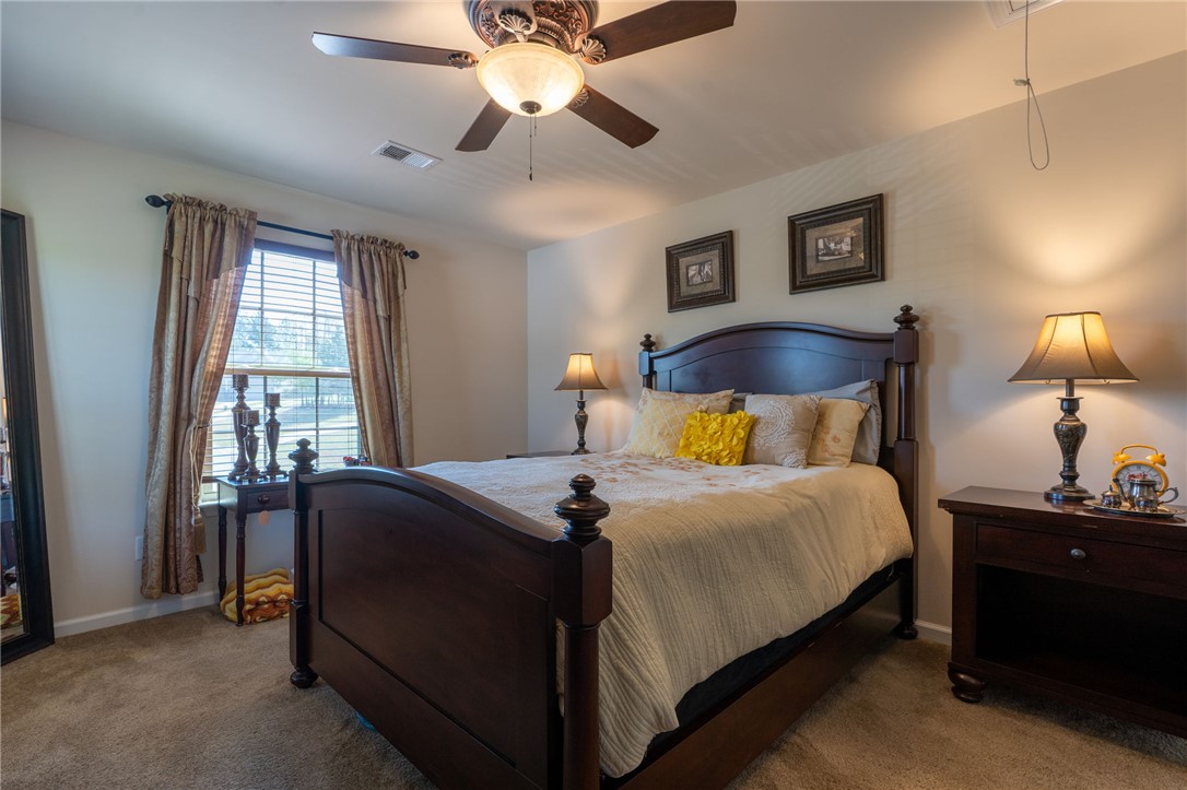 109 Smith Farm Way Easley, SC 29642 - Photo 19 of 37 This cozy bedroom features warm lighting and a classic aesthetic, perfect for quiet relaxation.