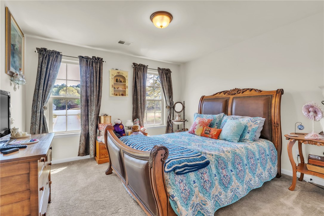 109 Smith Farm Way Easley, SC 29642 - Photo 21 of 37 Bright and airy, this bedroom provides a tranquil retreat with ample natural light.