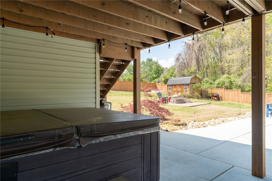 109 Smith Farm Way Easley, SC 29642 - Photo 30 of 37 Relax in the spa under the deck with views of the fenced backyard and storage shed.