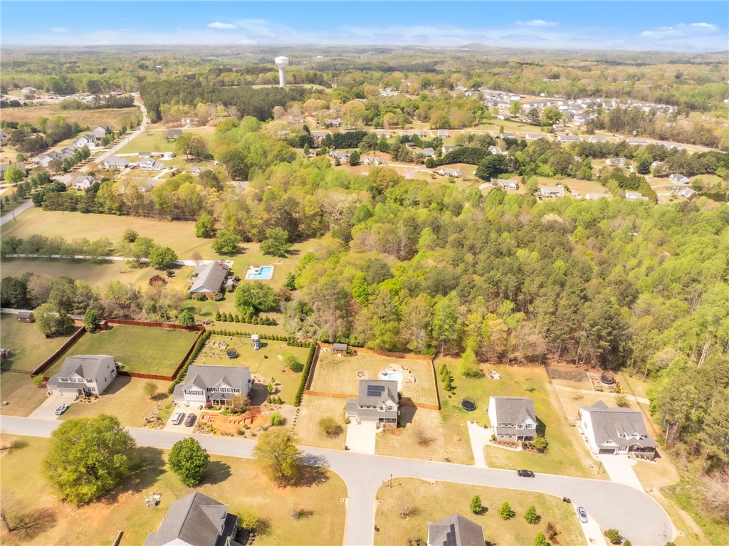 109 Smith Farm Way Easley, SC 29642 - Photo 37 of 37 An aerial perspective reveals a serene residential landscape nestled among lush greenery, featuring houses with private yards.