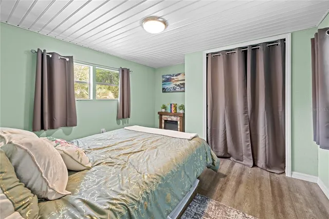 a bed room with a bed and a refrigerator