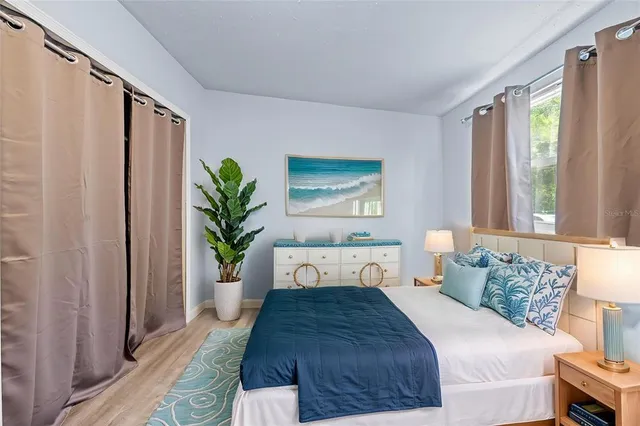 a bedroom with a large bed and a large window