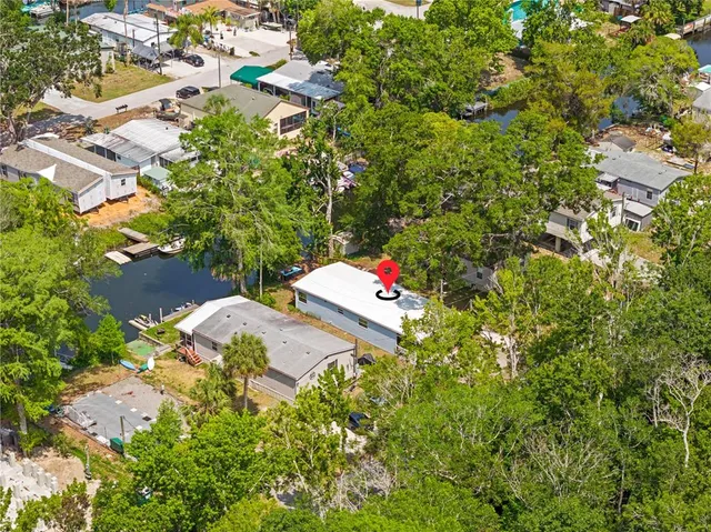 an aerial view of residential houses with outdoor space and lake view